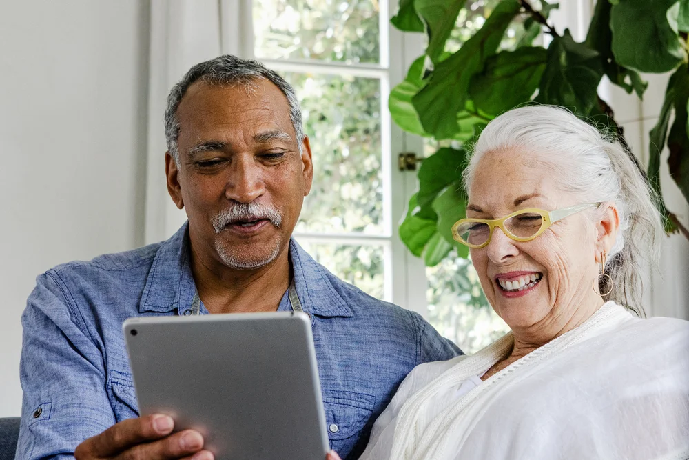 A couple exploring information together on a tablet